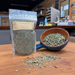 Herbal Smoking Blend in a 1 oz pouch beside a bowl of the loose mullein-based blend, hand-blended at Mayim Farm in Opp, Alabama
